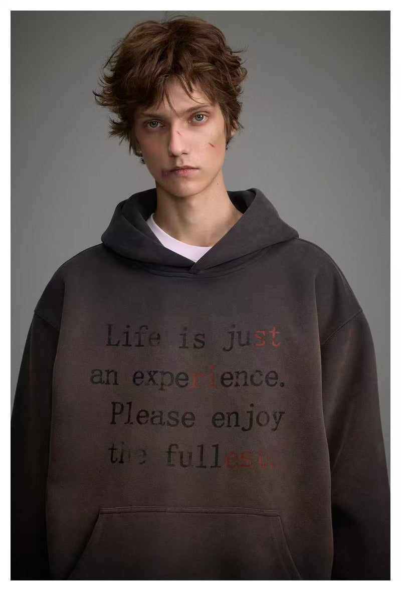 Close front view of dark washed hoodie with Life is just an experience text