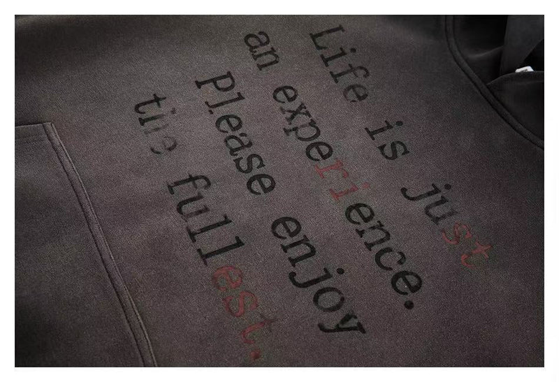 Close-up of hoodie front print reading Life is just an experience, please enjoy the fullest