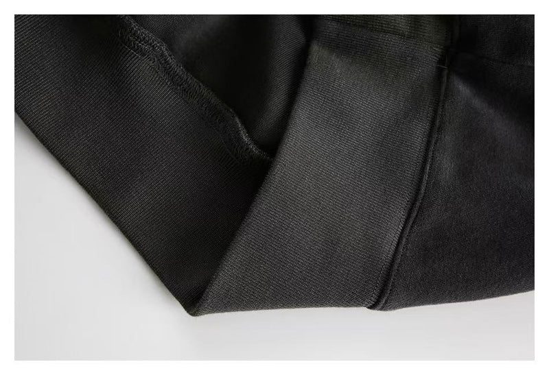 Close-up of dark hoodie sleeve cuff and hem seam