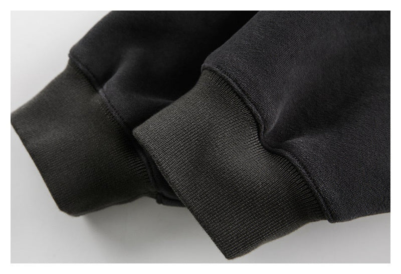 Close-up of black ribbed sleeve cuffs on the oversized hoodie