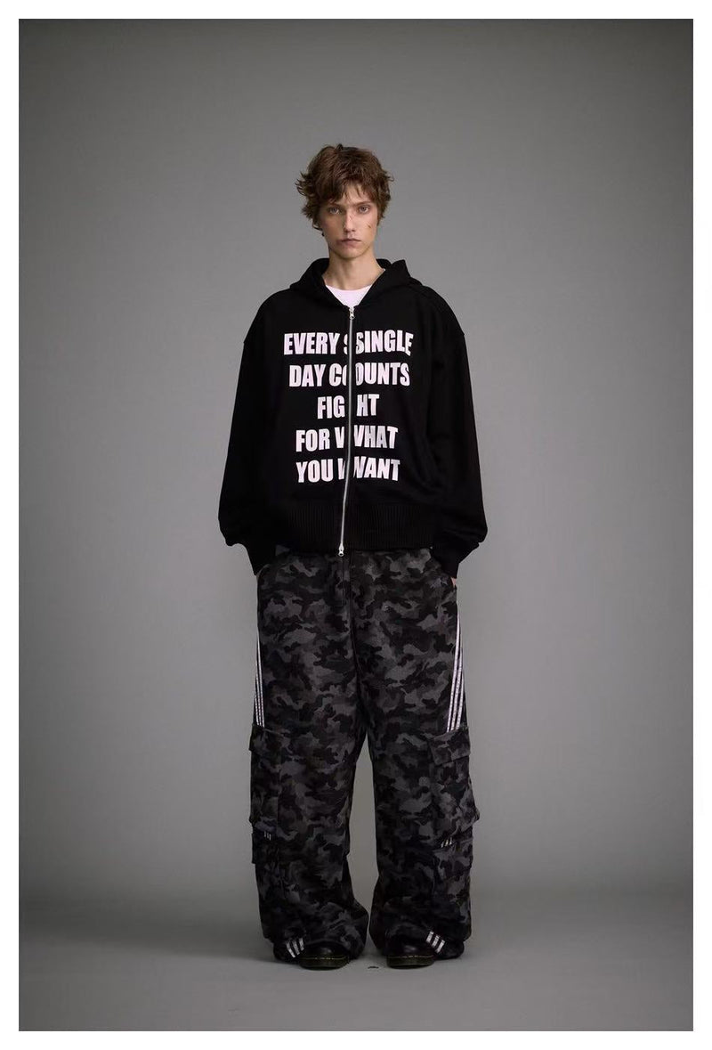Full-body model view wearing black zip-up hoodie and camouflage cargo pants