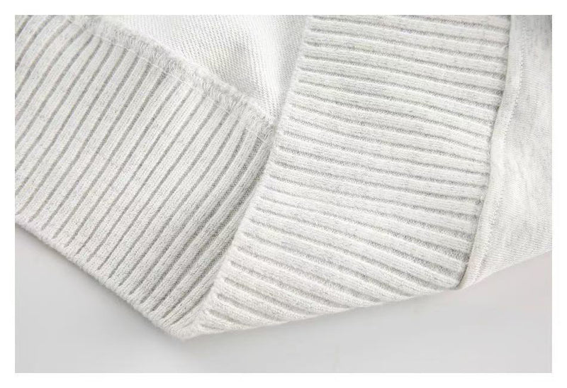 Close-up of white ribbed sleeve cuff and knit texture