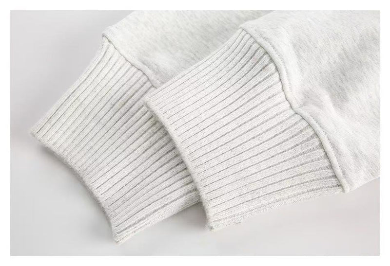 Close-up of white ribbed cuffs and sleeve hem