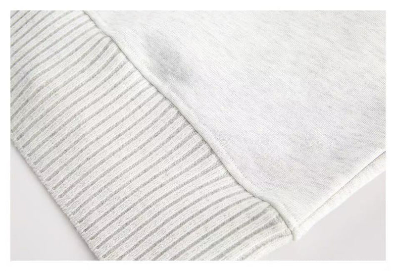 Close-up of white hoodie hem and ribbed cuff texture