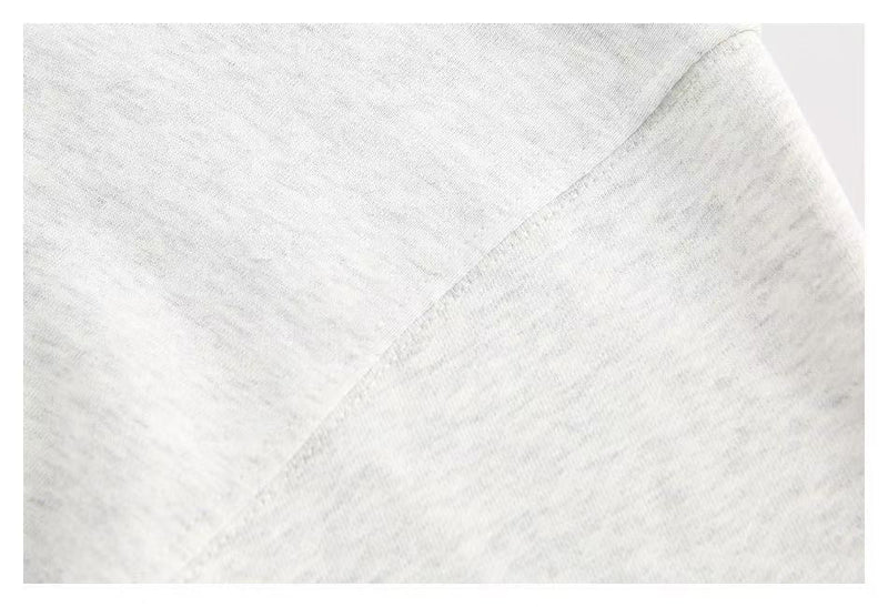 Close-up of white hoodie fabric seam and smooth knit texture