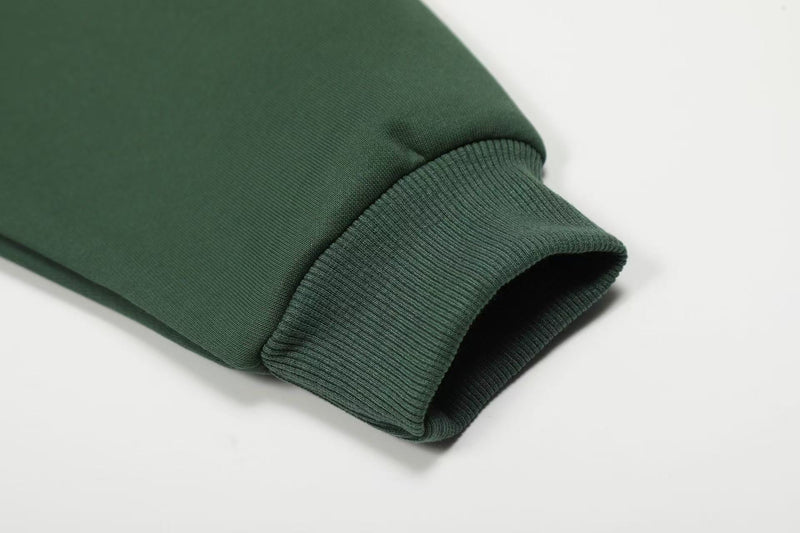 Close-up of dark green hoodie sleeve cuff and knit ribbing