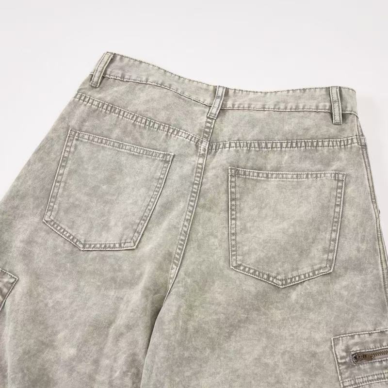 Close-up of back waistband and patch pockets on light wash cargo pants