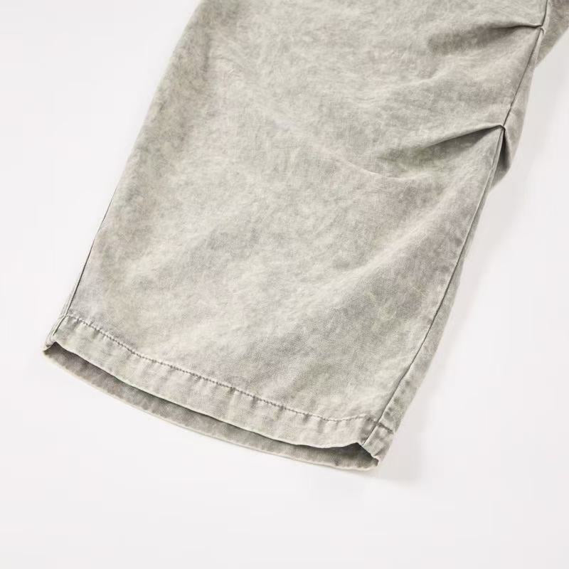 Close-up of hem and stitched cuff on light wash wide-leg cargo pants