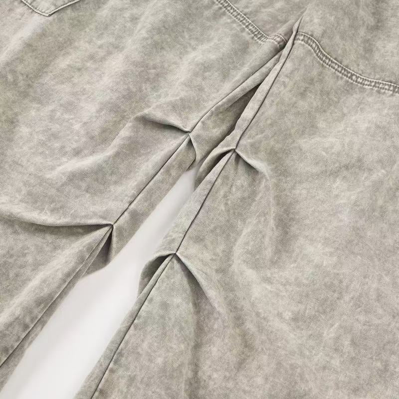 Close-up of pleated leg detail on light wash wide-leg cargo pants