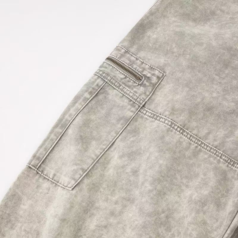 Close-up of side cargo pocket with zipper on light wash pants