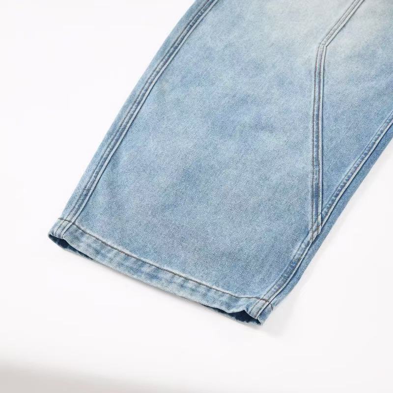 Close-up of light wash jeans cuff and hem on wide leg opening