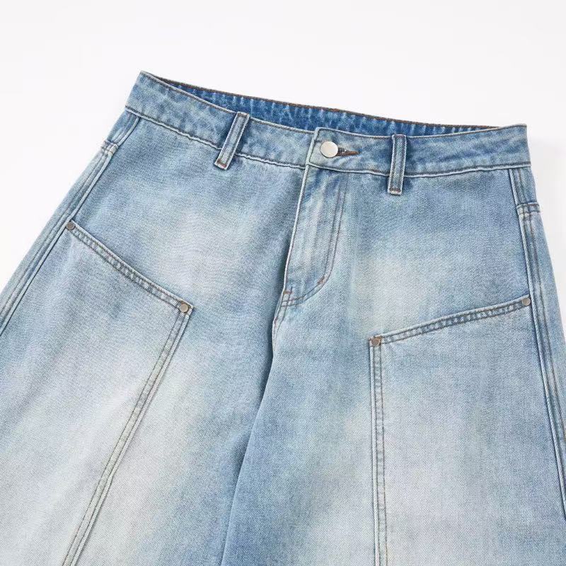 Close-up of light wash jeans front waistband, pockets, and button closure