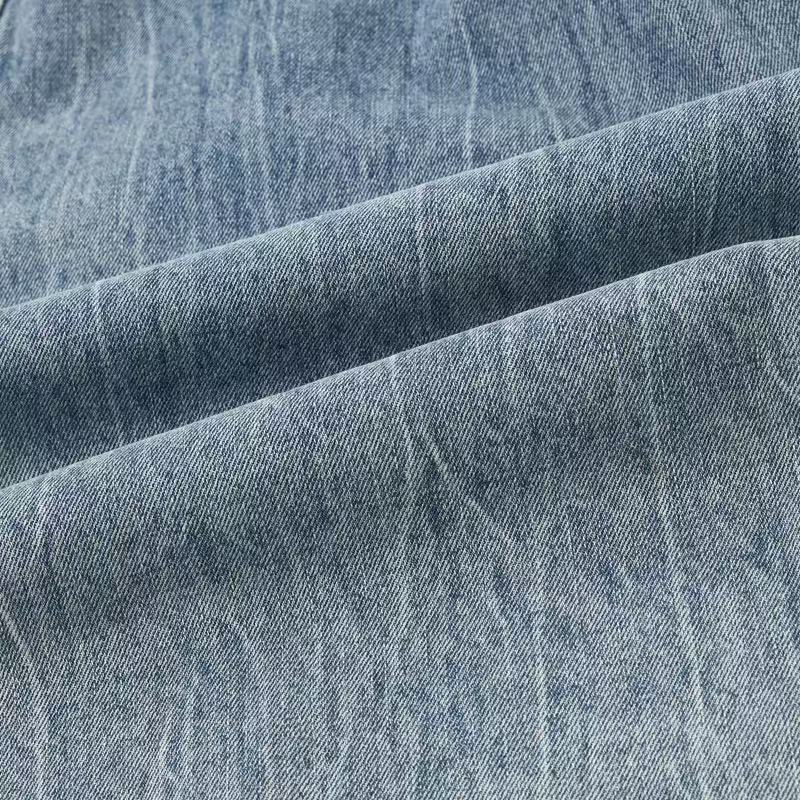 Close-up of light blue denim fabric with soft faded texture