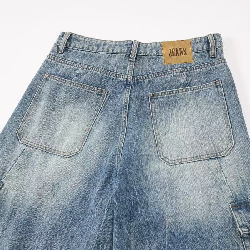 Back waistband close-up of light blue jeans with patch pockets and tan label