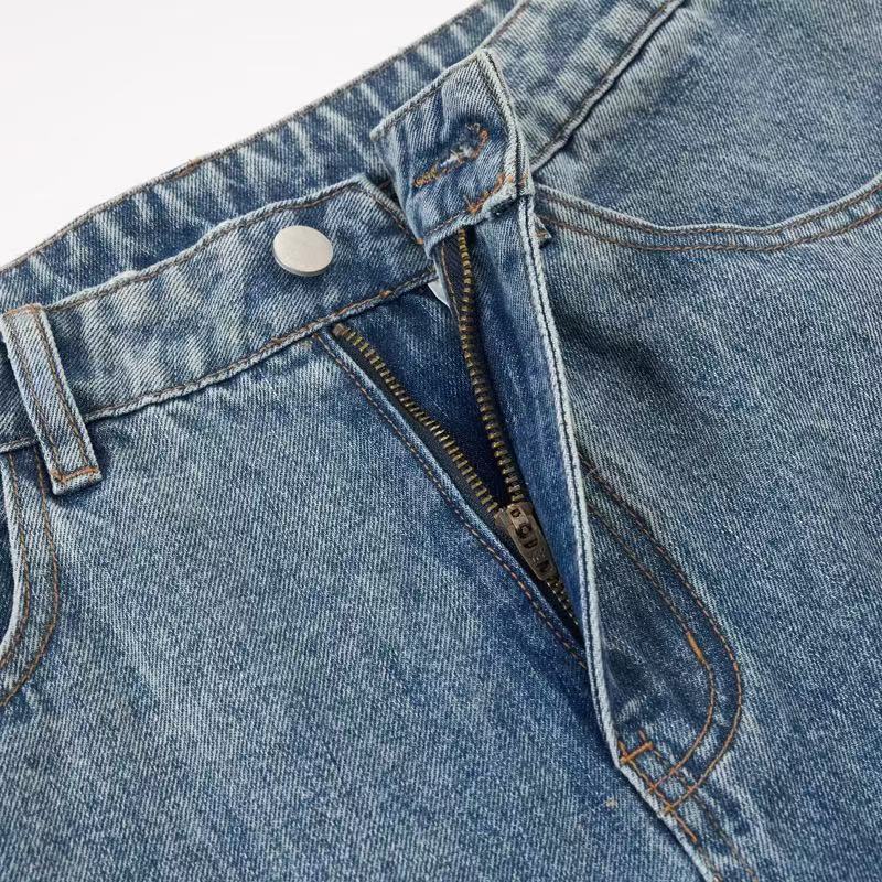 Zipper fly close-up on light blue denim jeans with metal button waistband