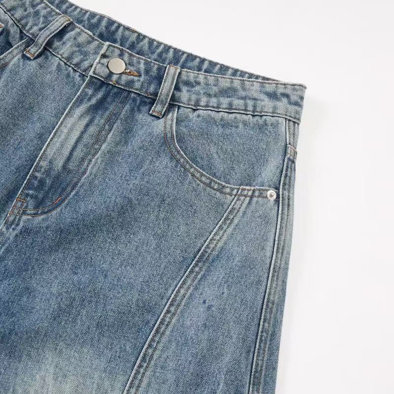 Front pocket close-up of faded blue denim jeans with curved pocket opening