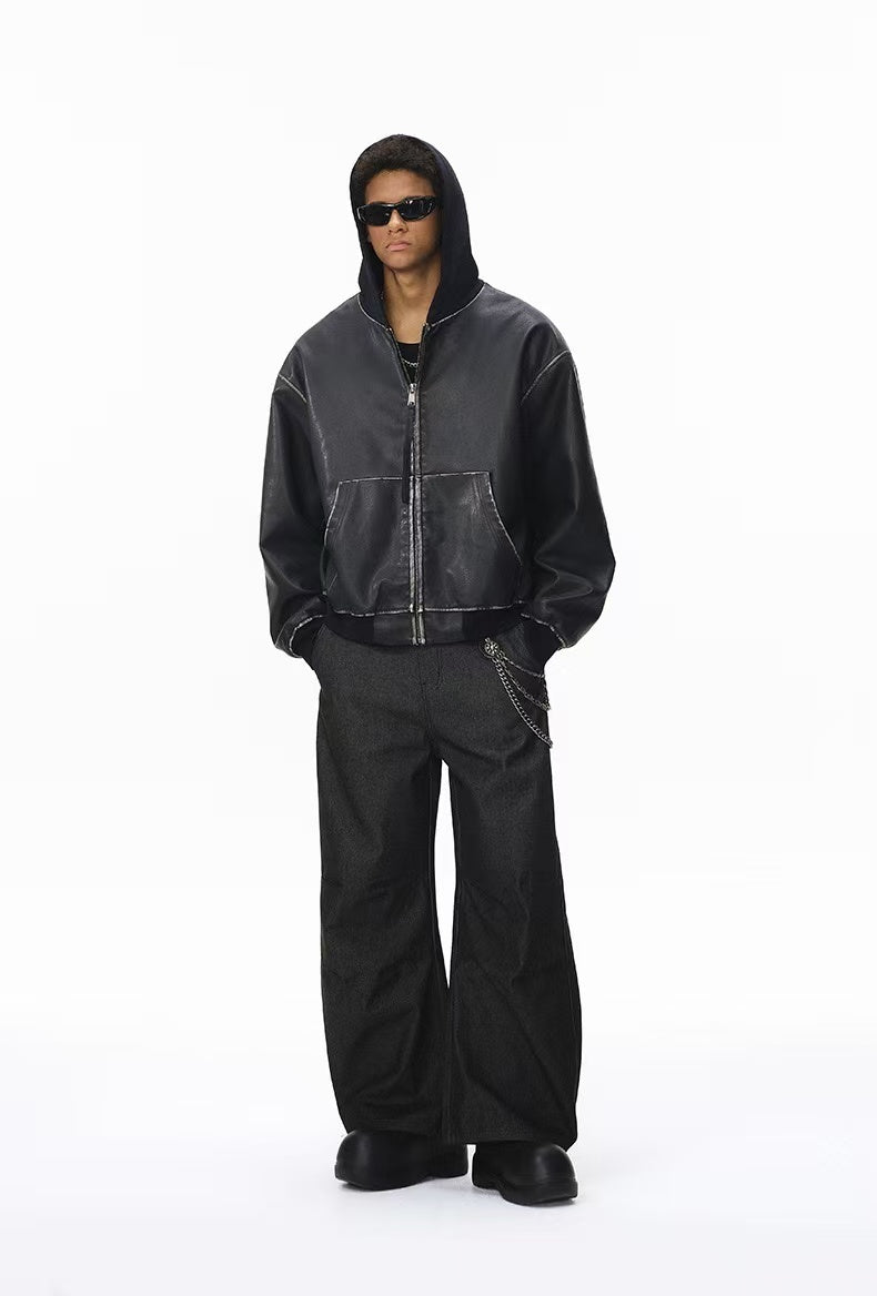 Model wearing black wide-leg pants and a hooded jacket, full-body front view