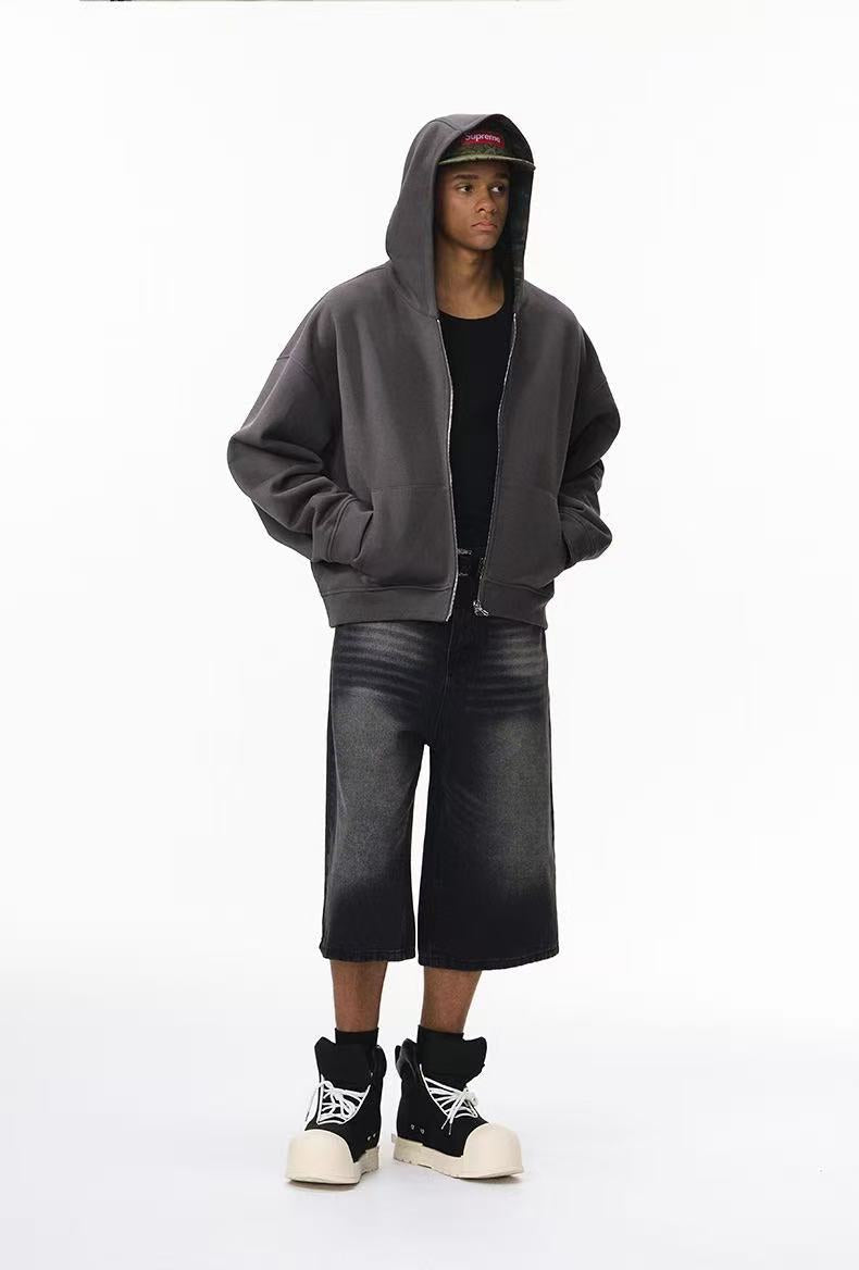 Full-length view of model wearing solid charcoal side hoodie with hood up