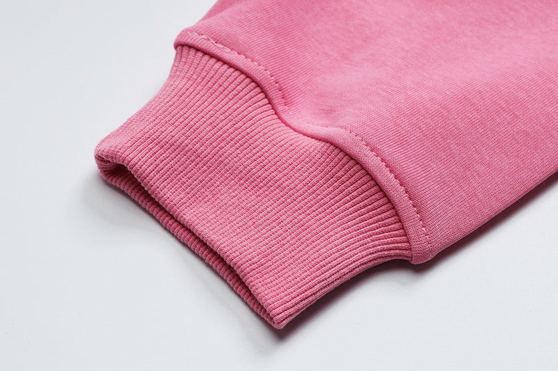 Close-up of pink hoodie ribbed cuff and sleeve seam