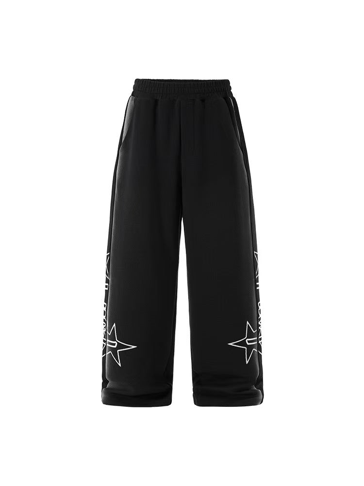Black wide-leg sweatpants with white star outline and text graphics printed on both legs, elastic waistband