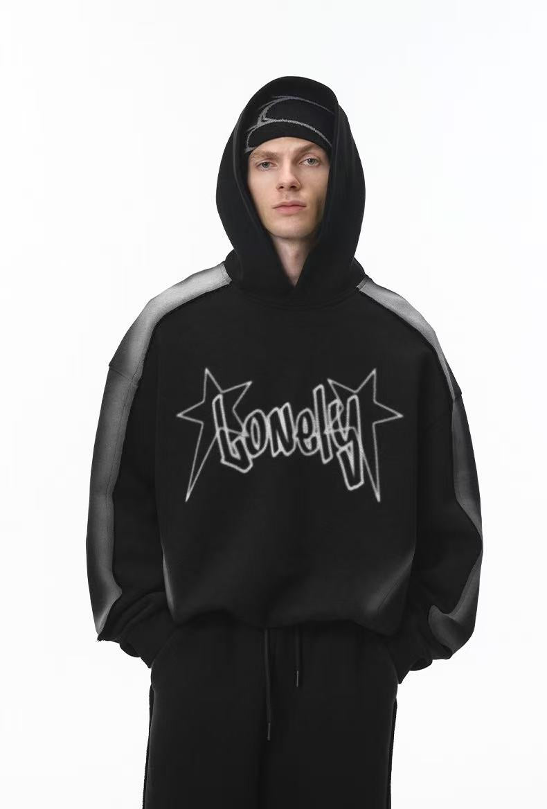 Front view of black cropped hoodie with hood up, star logo graphic, and gray shoulder panels