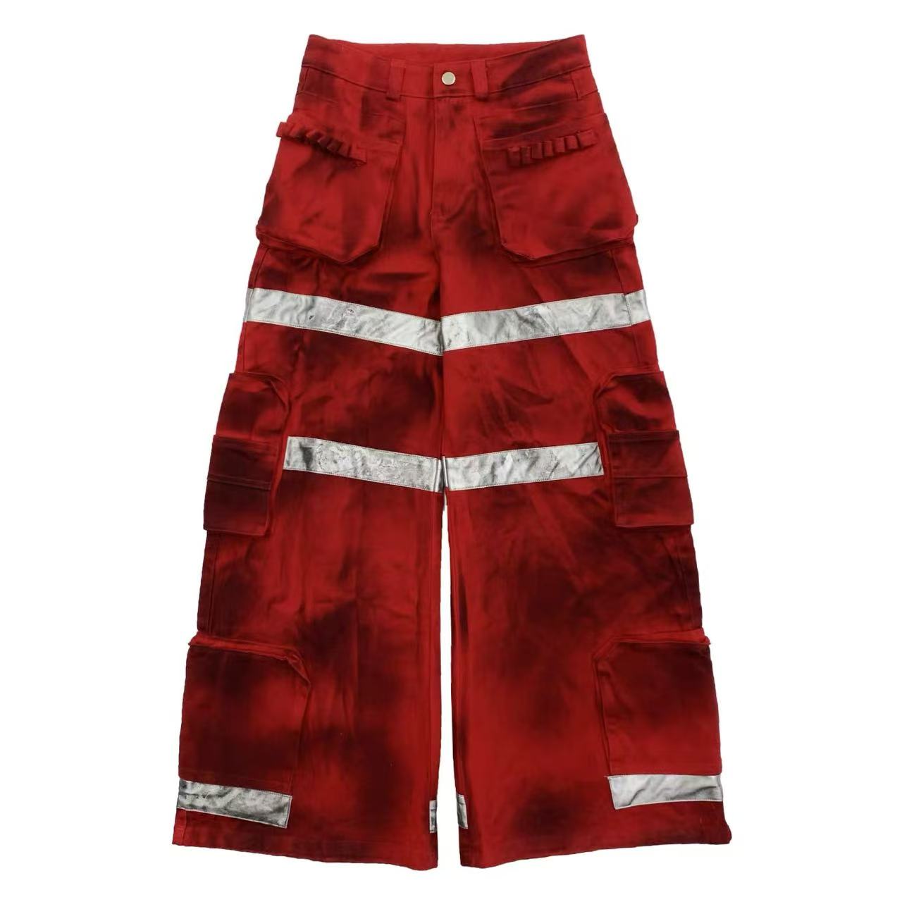 Red wide-leg cargo pants with silver reflective tape stripes and multiple cargo pockets on a white background
