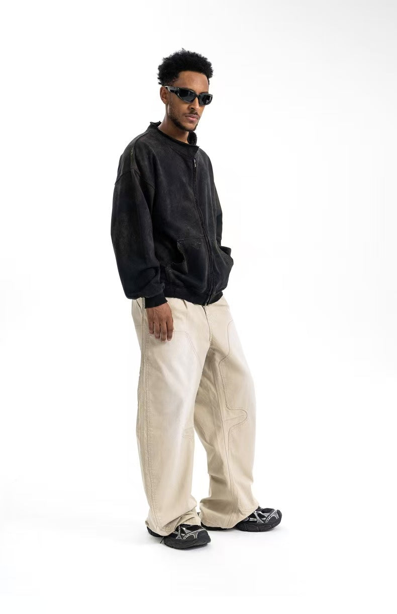 Beige carpenter pants on model, three-quarter view with wide legs and relaxed fit