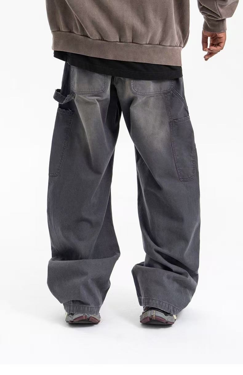 Washed gray carpenter pants on model, back view with side cargo pocket and loose fit