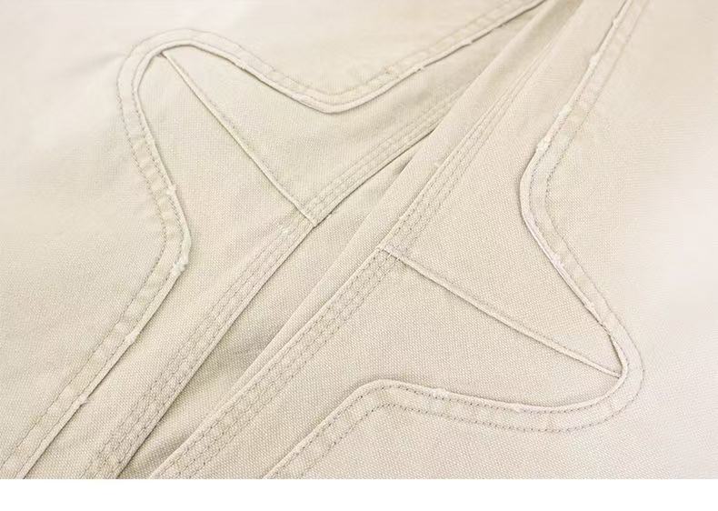 Beige pants curved seam close-up with contrast stitching