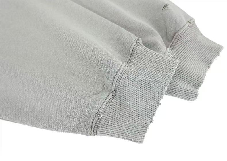 Light gray sweatshirt sleeve cuffs with ribbed knit trim and topstitching