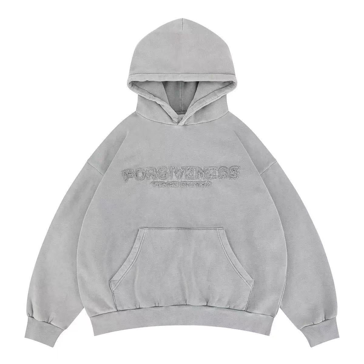 Light grey oversized hoodie with tonal 3D embroidered Forgiveness text on chest, kangaroo pocket, and ribbed cuffs