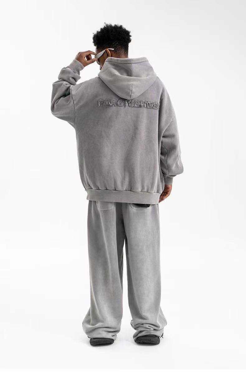 Back view of taupe oversized hoodie with Forgiveness embroidery across the upper back