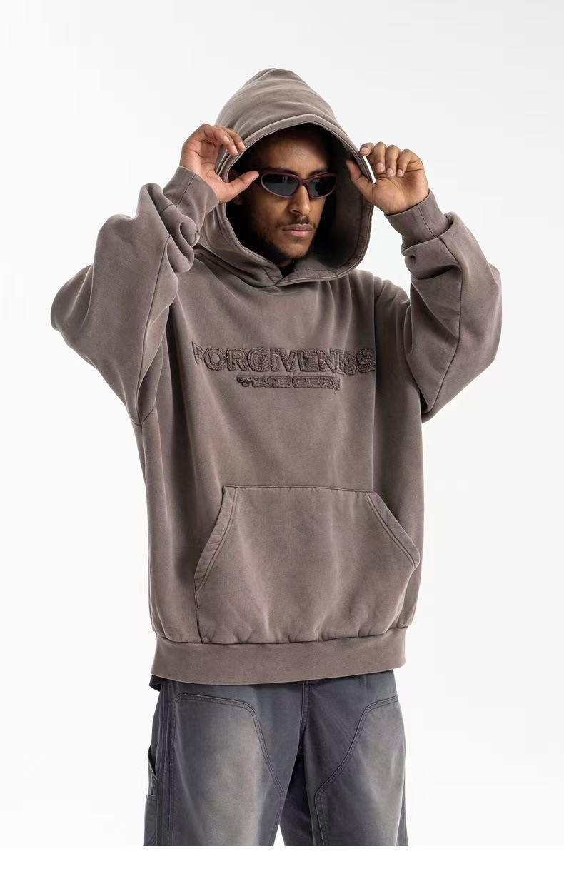 Upper front view of hooded brown-gray oversized hoodie with Forgiveness chest embroidery