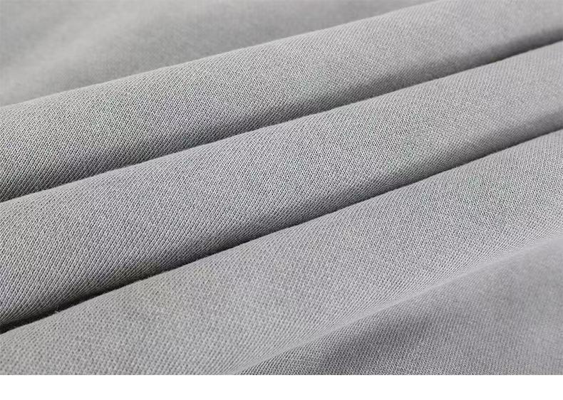 Close-up of gray hoodie fabric folds and smooth knit texture