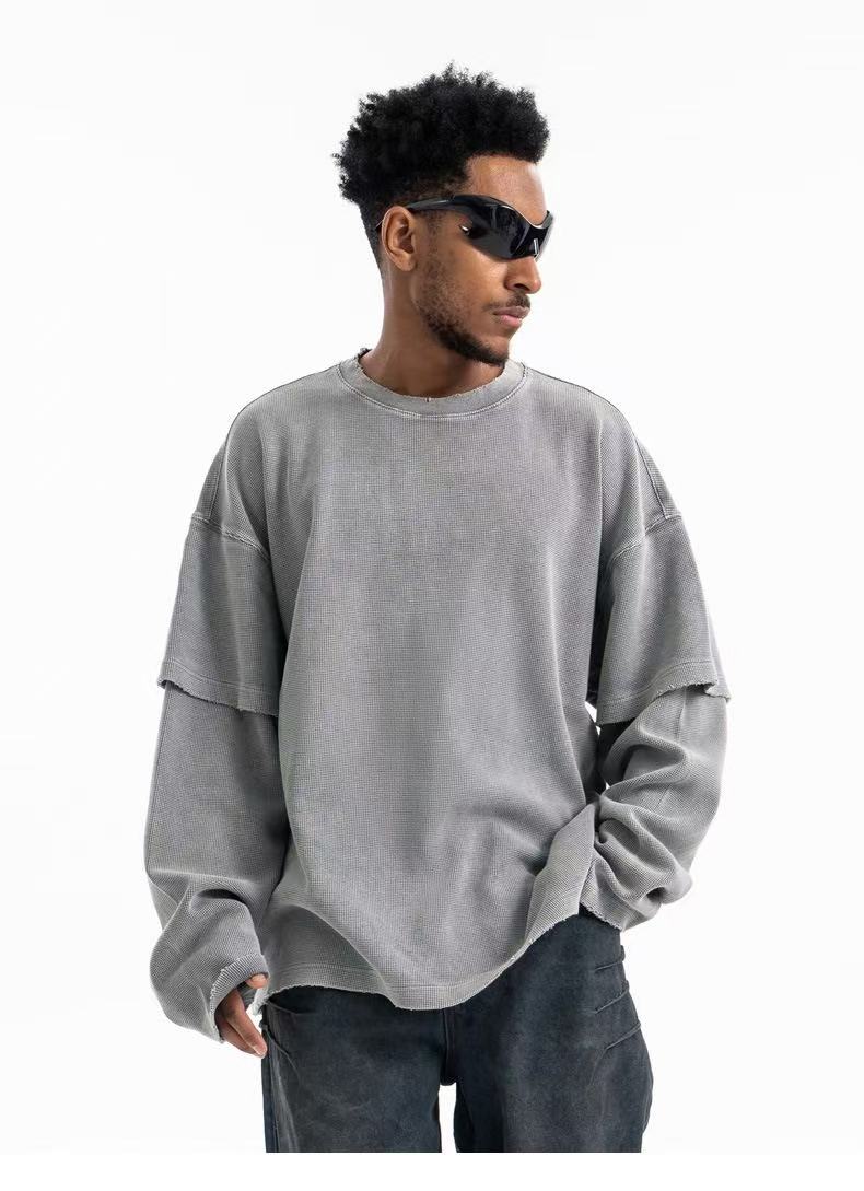 Gray corduroy crewneck sweatshirt front view on model with layered sleeves