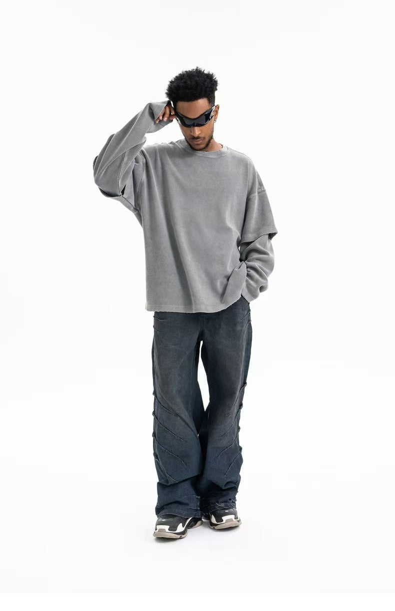 Gray oversized crewneck sweatshirt worn front view with hand raised to sunglasses
