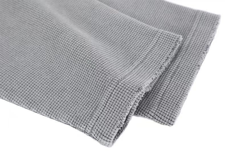 Close-up of gray corduroy cuff and layered hem edge