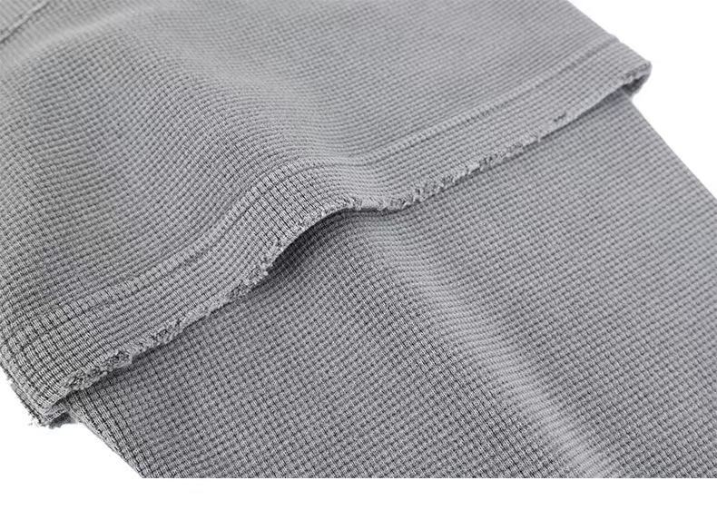 Close-up of gray corduroy sleeve cuff and frayed seam