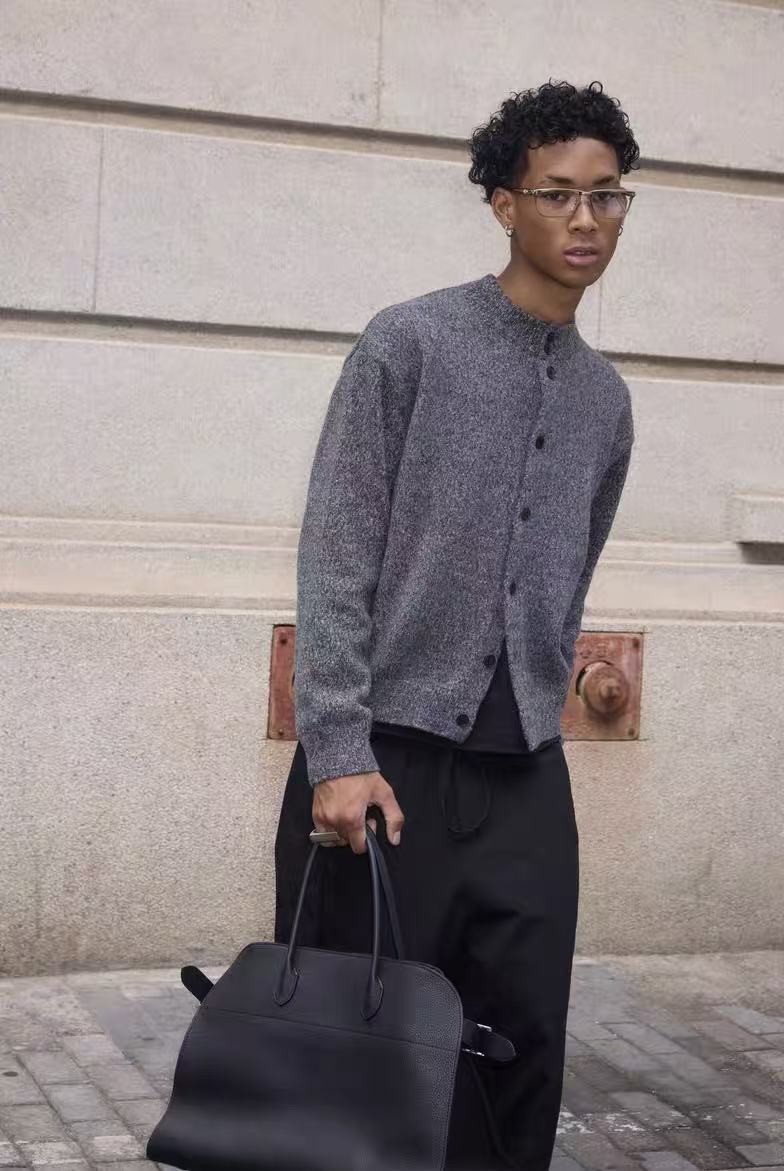 Gray cardigan worn at a slight angle with button front and long sleeves