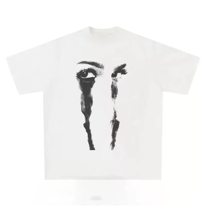 White oversized graphic tee with monochrome close-up eye portrait and ink-drip tear streaks printed on the chest