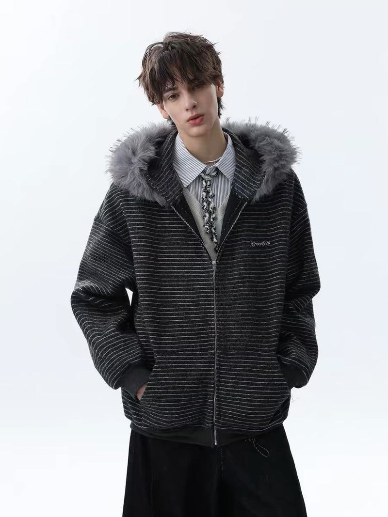 Model wearing black striped zip hoodie with gray faux fur hood trim, front view