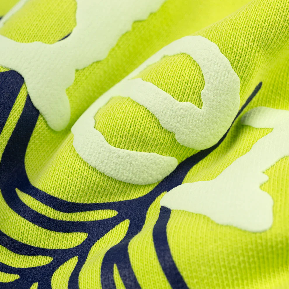 Close-up of the Sp5der Web Graphic Hoodie in neon green, made from 440GSM heavyweight streetwear fabric, showcasing raised light green and dark blue abstract spider web designs across the surface.