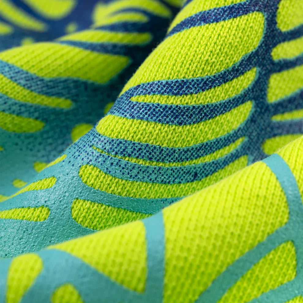 Close-up of the Sp5der Web Graphic Hoodie – Neon Green 440GSM Heavyweight Streetwear, showcasing its vibrant neon green fabric with bold blue web-like patterns. The textured fibers and soft folds create dynamic shadows and a sense of depth.
