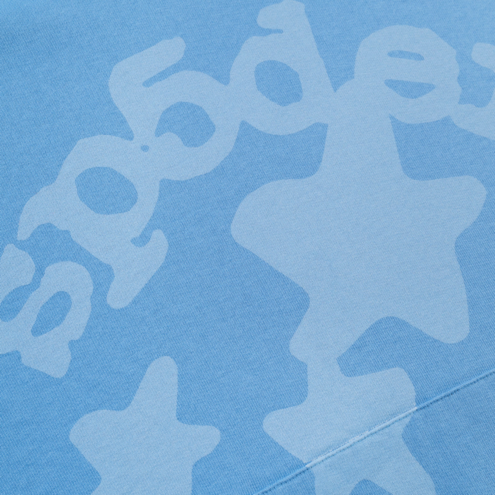 The Sp5der Star Hoodie – Baby Blue 440GSM Heavyweight Oversized Streetwear Pullover features a subtle white star print and abstract letters, ideal for Y2K streetwear fans or anyone wanting a fresh, bold vibe.
