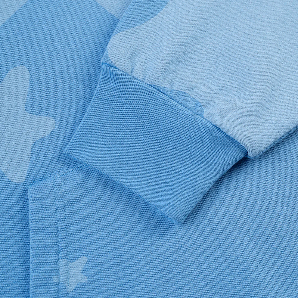 Close-up of the Sp5der Star Hoodie – Baby Blue 440GSM Heavyweight Oversized Streetwear Pullover sleeve, featuring ribbed cuffs and subtle star-like patterns—ideal for a bold Y2K-inspired look.