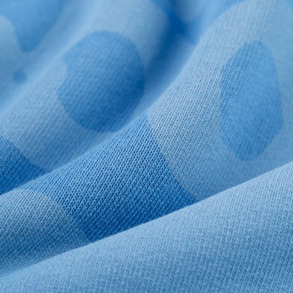Close-up of the Sp5der Star Hoodie in Baby Blue, showcasing its darker blue polka dot pattern. The heavyweight 440GSM cotton fleece feels cozy, while gentle folds highlight the oversized streetwear pullover’s soft texture.