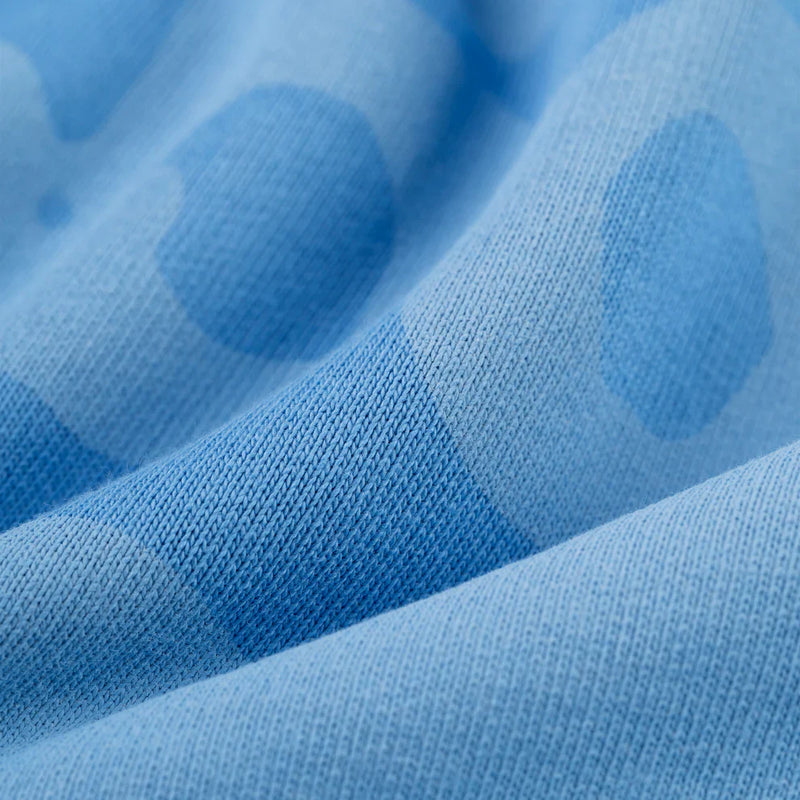 Close-up of the Sp5der Star Hoodie in Baby Blue, showcasing its darker blue polka dot pattern. The heavyweight 440GSM cotton fleece feels cozy, while gentle folds highlight the oversized streetwear pullover’s soft texture.