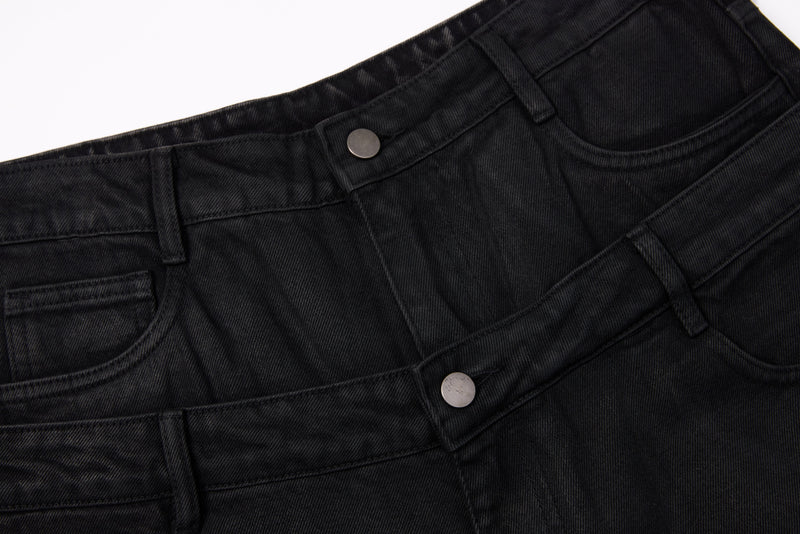 Close-up of black denim double waist and front pockets with metal button details