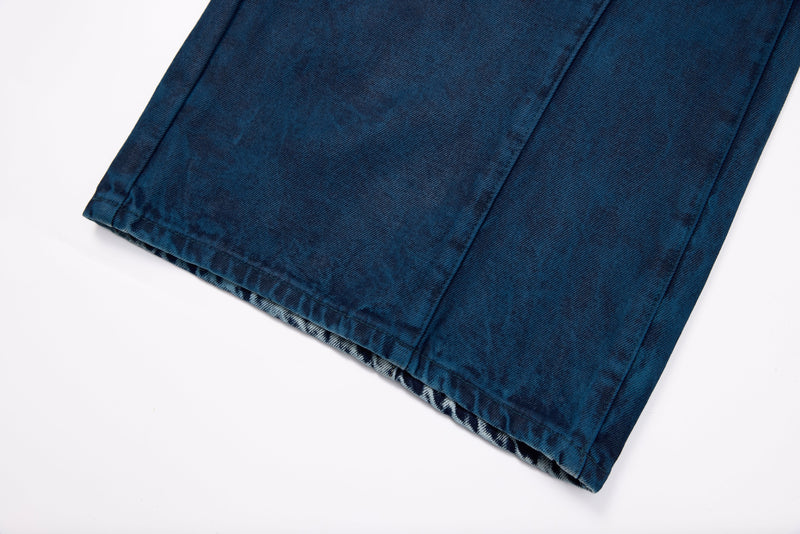 Close-up of wide leg hem on dark blue denim jeans with patterned inner lining