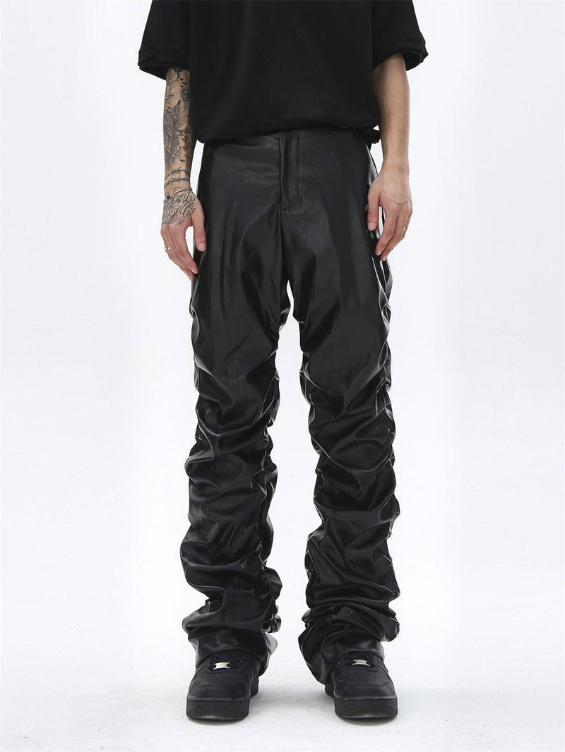 Black faux leather straight-leg pants worn with front view, ruched legs and loose fit